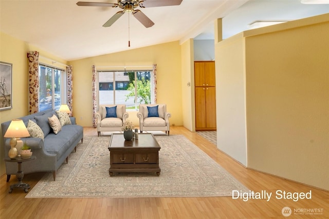 living room with light wood-type flooring, ceiling fan, and vaulted ceiling