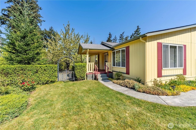 view of side of property with a yard