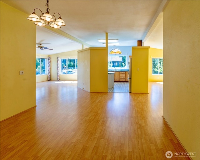 unfurnished room featuring lofted ceiling with beams, light wood-type flooring, and ceiling fan with notable chandelier