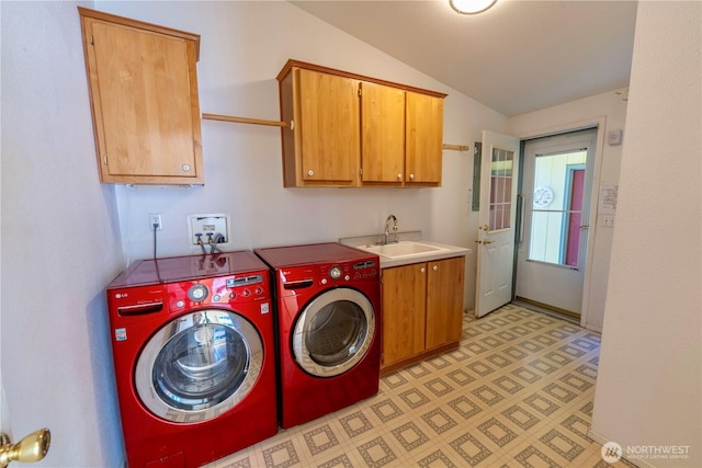 clothes washing area with cabinet space, independent washer and dryer, light floors, and a sink