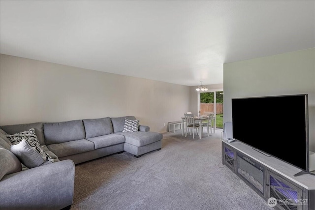 living room featuring light carpet and a notable chandelier