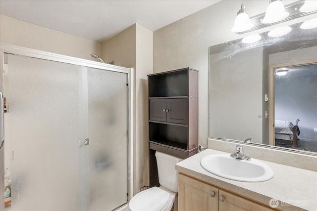 bathroom featuring vanity, toilet, and a shower stall