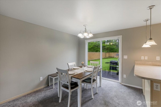 carpeted dining room with baseboards and a notable chandelier