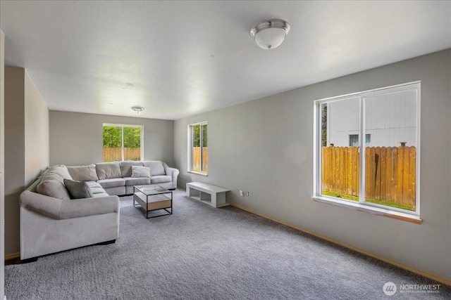 carpeted living room with baseboards