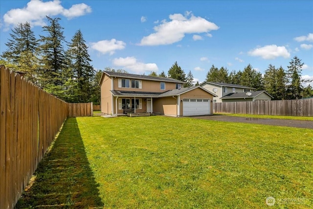 traditional home with a front lawn, aphalt driveway, a garage, and a fenced backyard