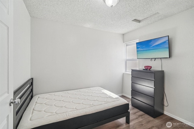 3420SW 344th St, Federal Way, WA 98023 - bedroom featuring a textured ceiling, wood finished floors, and baseboards