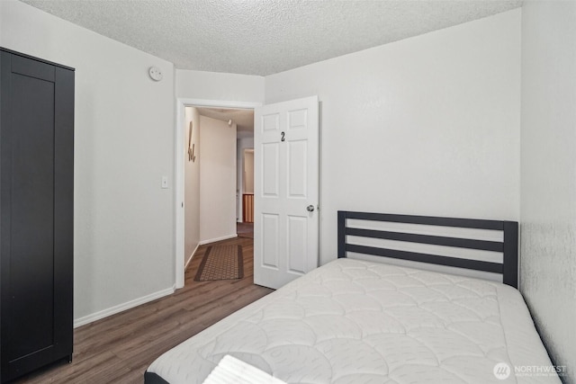 3420SW 344th St, Federal Way, WA 98023 - bedroom featuring wood finished floors, a textured ceiling, and baseboards