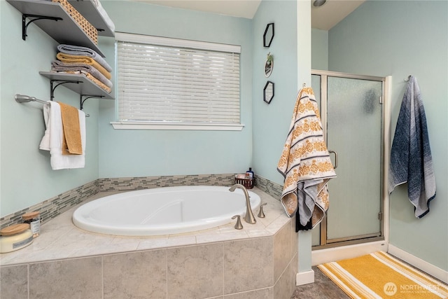 full bathroom featuring a garden tub and a stall shower