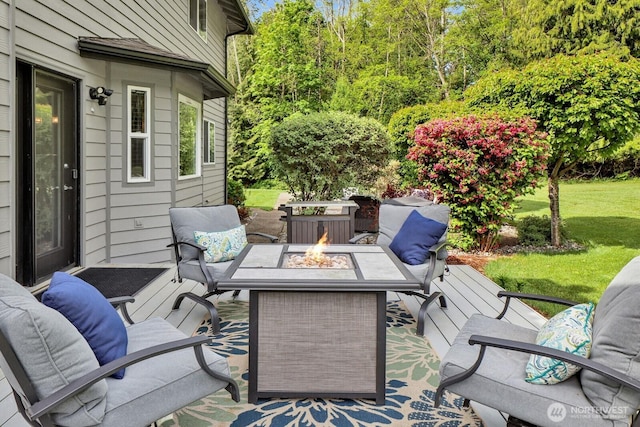 view of patio / terrace with an outdoor living space with a fire pit