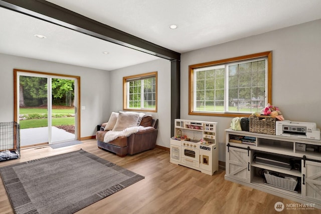 sitting room with baseboards, recessed lighting, and light wood-type flooring
