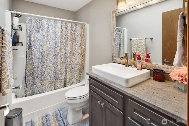 bathroom with vanity, toilet, and shower / bath combo