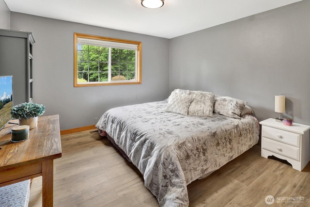 bedroom with baseboards and light wood-style floors