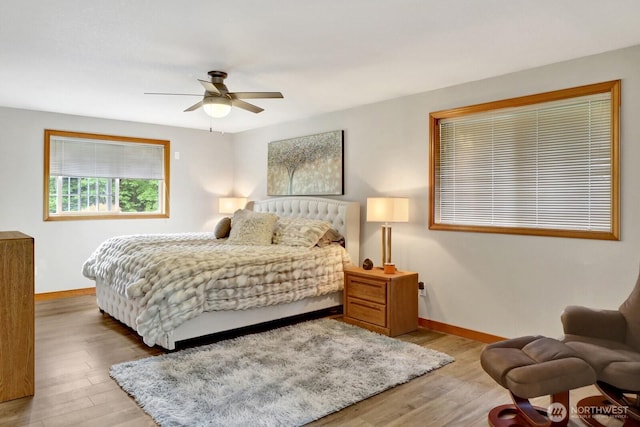 bedroom featuring baseboards, ceiling fan, and wood finished floors