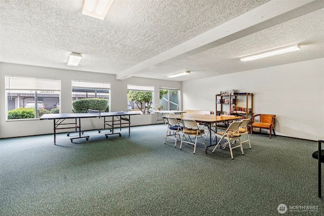 carpeted dining room with a textured ceiling