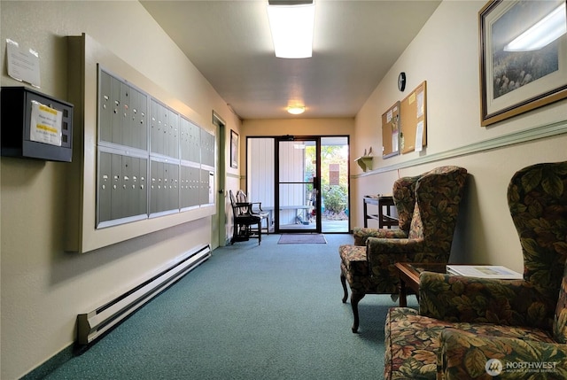 interior space with carpet, mail area, and a baseboard heating unit