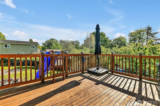 wooden terrace featuring a playground