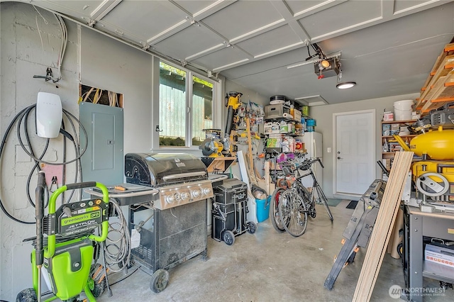 garage featuring electric panel and a garage door opener