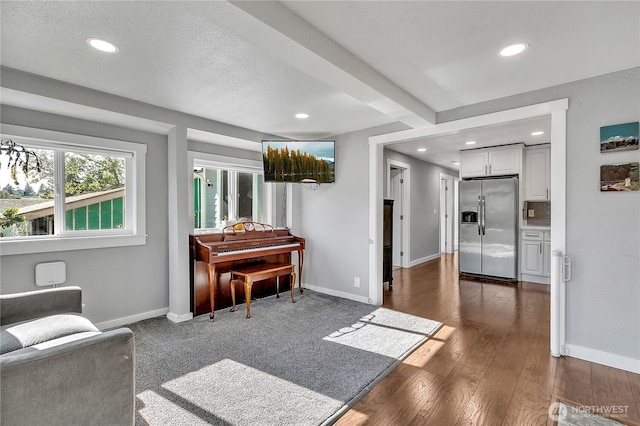 sitting room featuring a textured ceiling, dark wood-style flooring, baseboards, and recessed lighting