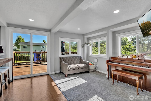 sunroom featuring beam ceiling