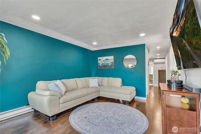 living area with recessed lighting, a wall mounted AC, and wood finished floors