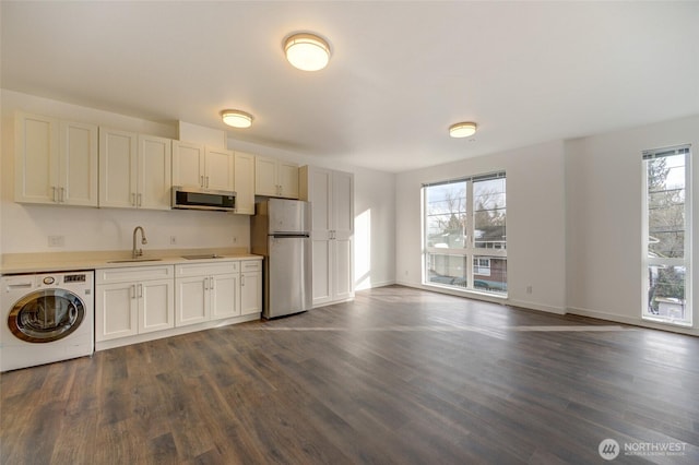 2508 N 50th St, Seattle, WA 98103 - kitchen featuring a healthy amount of sunlight, washer / clothes dryer, appliances with stainless steel finishes, and a sink