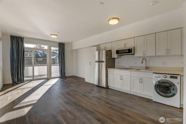 2508 N 50th St, Seattle, WA 98103 - kitchen featuring a sink, washer / clothes dryer, dark wood finished floors, light countertops, and appliances with stainless steel finishes
