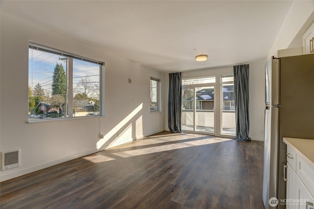 2508 N 50th St, Seattle, WA 98103 - unfurnished dining area with baseboards, visible vents, and dark wood finished floors