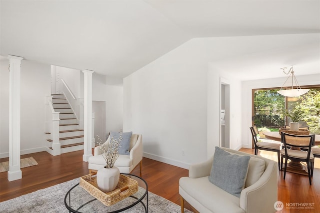 sitting room featuring decorative columns, lofted ceiling, stairway, wood finished floors, and baseboards