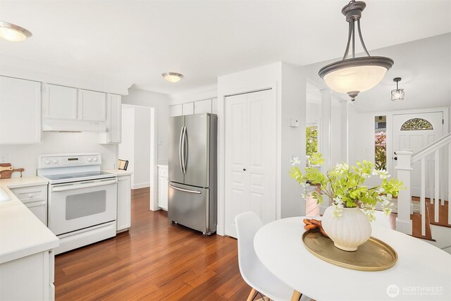kitchen featuring freestanding refrigerator, white electric range, under cabinet range hood, dark wood-type flooring, and white cabinetry