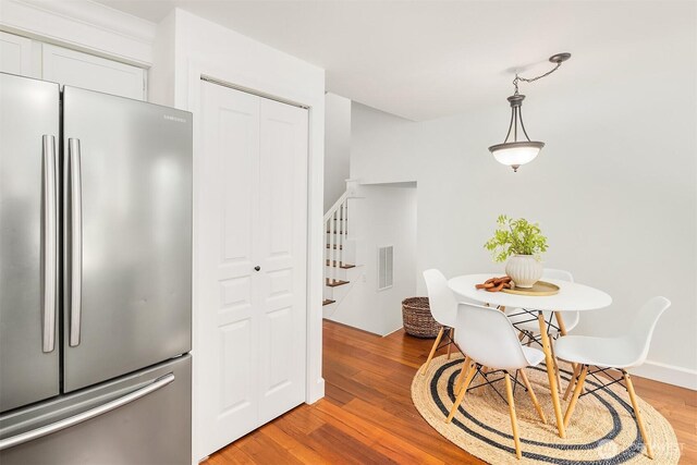dining room featuring stairs and light wood finished floors