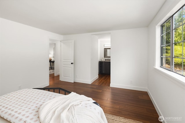 bedroom featuring hardwood / wood-style floors and baseboards