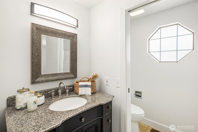 bathroom featuring toilet and vanity