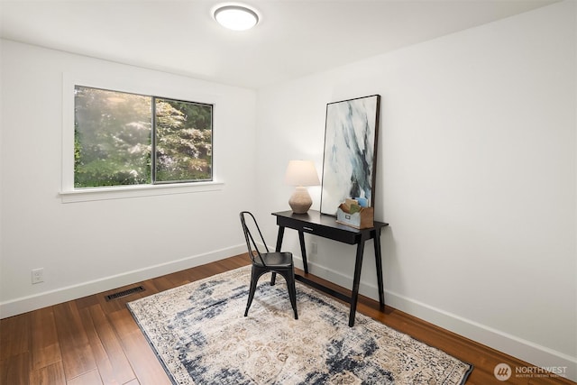 office area with dark wood finished floors and baseboards