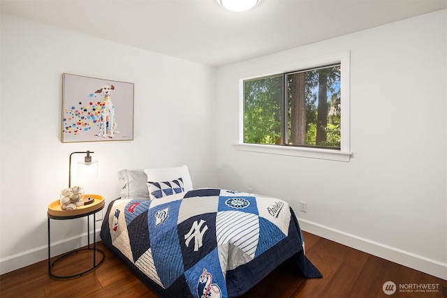 bedroom featuring baseboards and wood finished floors