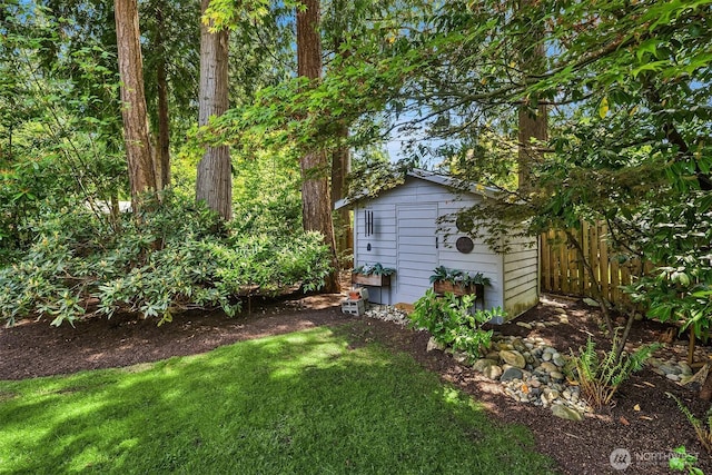 view of yard featuring a shed and an outdoor structure