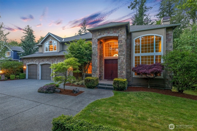 25846 NE 4th Pl, Sammamish, WA 98074 - view of front facade with stone siding, a chimney, an attached garage, driveway, and a lawn