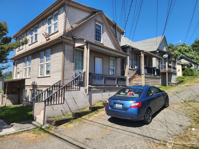 view of front of home featuring stairs and a porch
