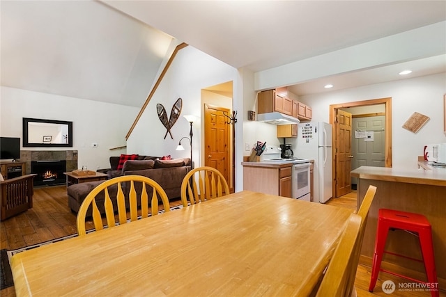 12026 Shuksan Rim Dr, Deming, WA 98244 - dining area featuring light wood finished floors, recessed lighting, and a lit fireplace