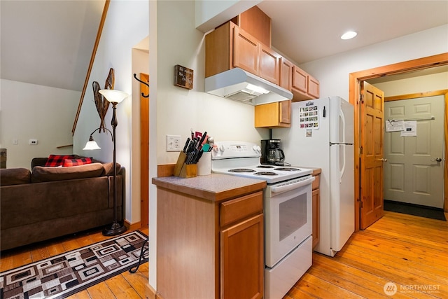 12026 Shuksan Rim Dr, Deming, WA 98244 - kitchen with white appliances, under cabinet range hood, light wood-type flooring, open floor plan, and light countertops