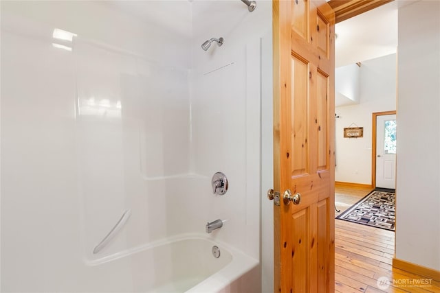 12026 Shuksan Rim Dr, Deming, WA 98244 - bathroom featuring wood-type flooring, tub / shower combination, and baseboards