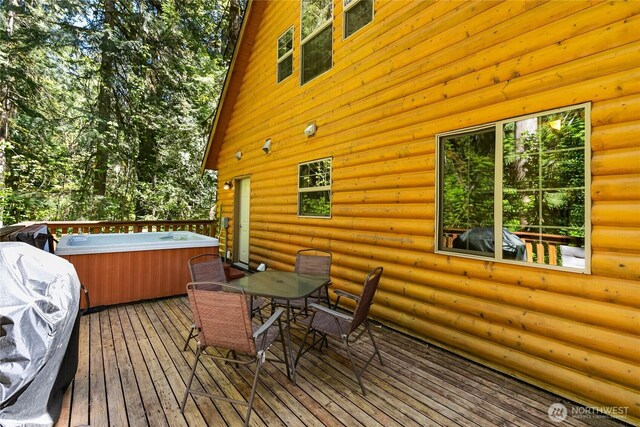 12026 Shuksan Rim Dr, Deming, WA 98244 - wooden terrace featuring a hot tub, outdoor dining space, and grilling area