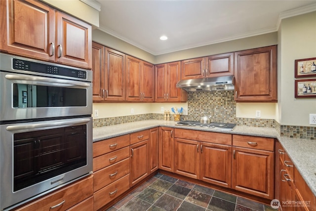 215 20th Ave E Unit 305, Seattle, WA 98112 - kitchen featuring under cabinet range hood, stainless steel appliances, brown cabinets, backsplash, and crown molding