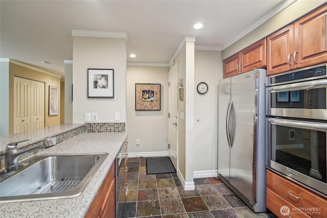 215 20th Ave E Unit 305, Seattle, WA 98112 - kitchen featuring stainless steel appliances, a sink, baseboards, brown cabinets, and ornamental molding