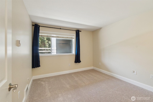 unfurnished room with carpet flooring and baseboards