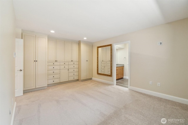 unfurnished bedroom with baseboards, light carpet, recessed lighting, and connected bathroom
