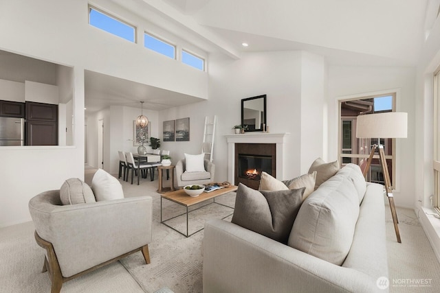 522 W Mercer Pl Unit 401, Seattle, WA 98119 - living area with light carpet, a towering ceiling, a glass covered fireplace, and recessed lighting