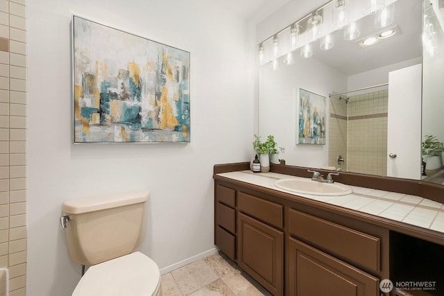 522 W Mercer Pl Unit 401, Seattle, WA 98119 - bathroom with vanity, toilet, baseboards, and a shower