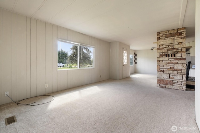 252 Romerman Rd, Chehalis, WA 98532 - unfurnished living room with visible vents, wood walls, and carpet floors