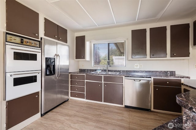 252 Romerman Rd, Chehalis, WA 98532 - kitchen with dark stone counters, stainless steel appliances, dark brown cabinets, and a sink