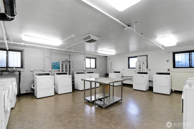 1105 Spring St Unit 1306, Seattle, WA 98104 - community laundry room featuring washing machine and dryer and plenty of natural light